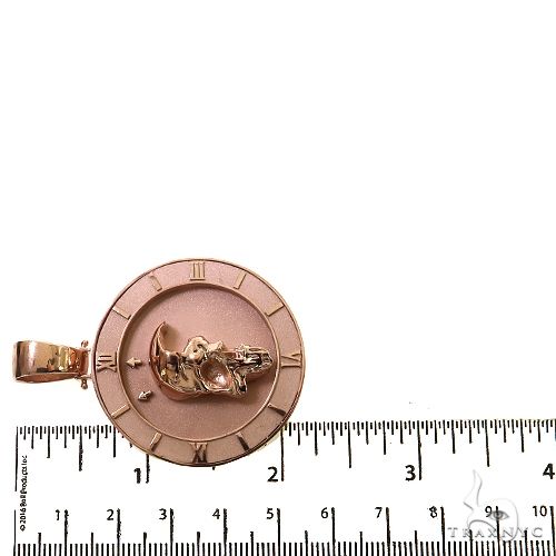 Rose gold pendant featuring a half skull design with Roman numeral border and bail loop