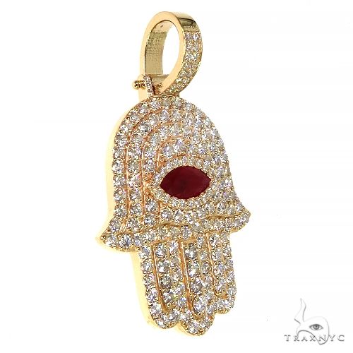 Yellow gold Hamsa pendant with diamonds and a marquise red gemstone center