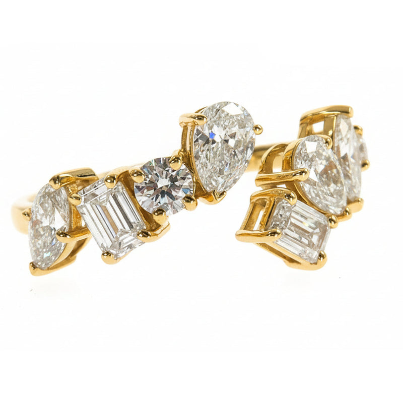 White gold ring with pear and emerald cut lab diamonds in an asymmetrical cluster design
