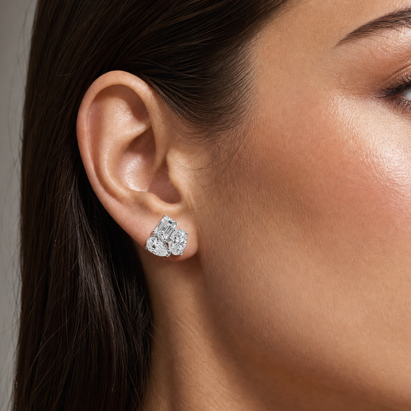White gold cluster stud earrings with trio of sparkling diamonds on ear