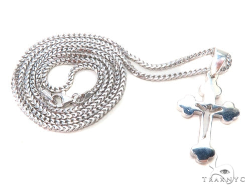 Sterling silver crucifix pendant, front view – high-relief cross form in polished white silver