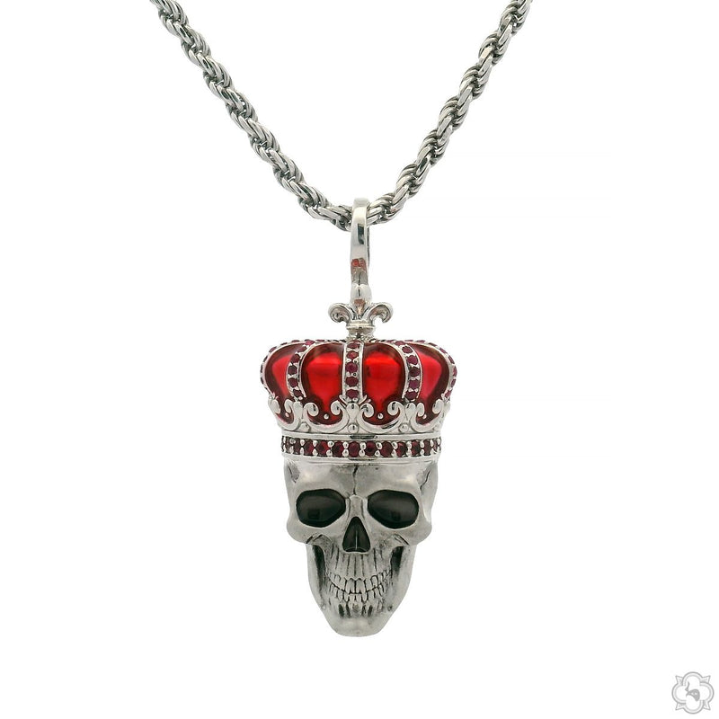 Silver skull pendant with red gemstone crown on twisted chain necklace