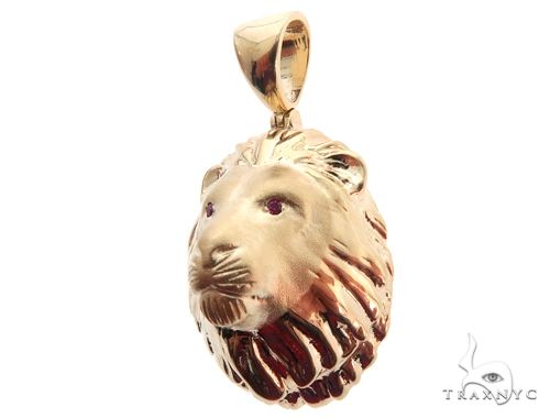 Yellow gold lion head pendant with detailed mane and ruby red eyes, small men's accessory