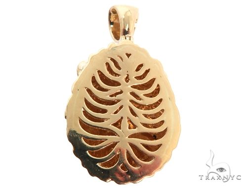 Yellow gold lion head pendant with ruby eyes and intricate cutout detailing