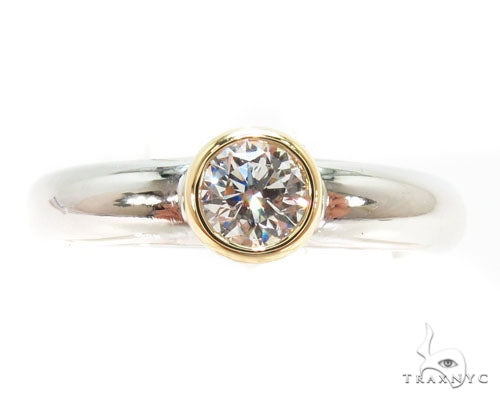 Mens platinum wedding band with 18K yellow gold bezel and round diamond center stone