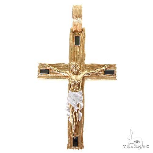 Yellow gold cross pendant with detailed Jesus figure and black stone accents