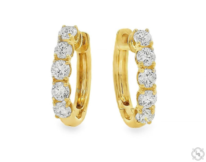 Mini diamond huggie hoop earrings in yellow gold – close-to-ear profile with pavé diamond detail