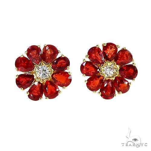 Pear-shaped red sapphire flower cluster earrings with central white gemstone and yellow gold setting