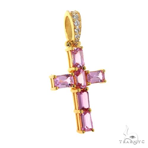 Gold cross pendant with pink emerald-cut sapphire gemstones and diamond accents on bail