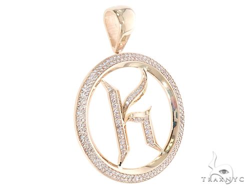 Yellow gold prong-set diamond initial K pendant with round frame and polished finish