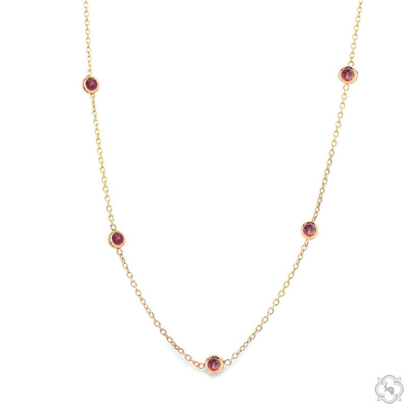 Yellow gold necklace with five round red sapphire bezel-set gemstones