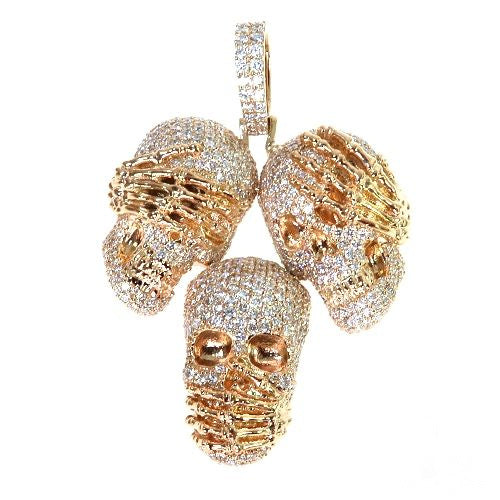Three rose gold skull pendants encrusted with diamonds showing see no evil, hear no evil, speak no evil