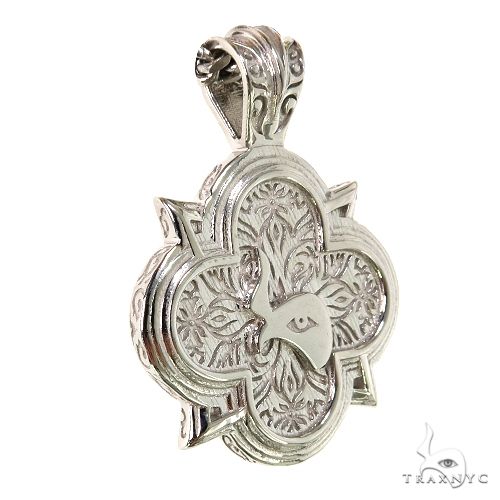 Silver Trax logo pendant with intricate floral engraving and polished finish