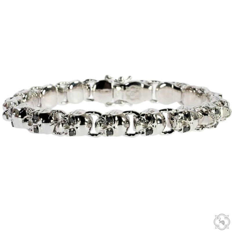 Silver bracelet featuring linked skull charms with intricate detailing and polished finish