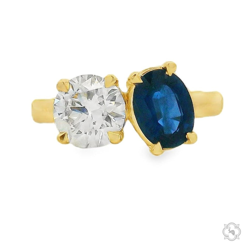 Yellow gold ring with round diamond and oval sapphire gemstones in a Toi et Moi style