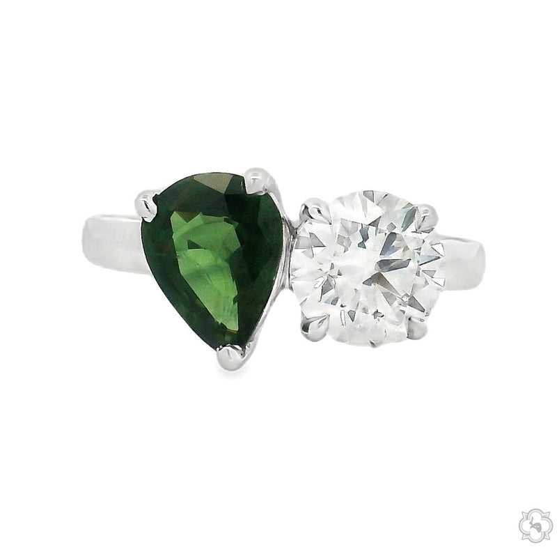 White gold ring with pear-shaped green sapphire and round brilliant diamond gemstones