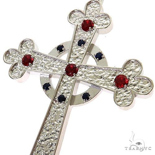 .925 silver cross pendant with textured design and red and black gemstone accents