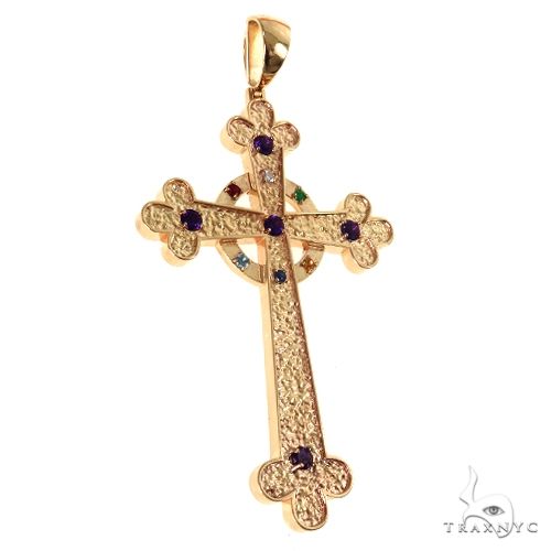 Yellow gold cross pendant with purple gemstones and intricate textured design