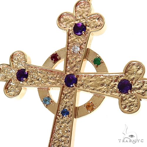 Yellow gold cross pendant with textured surface and multicolored gemstones at center and edges