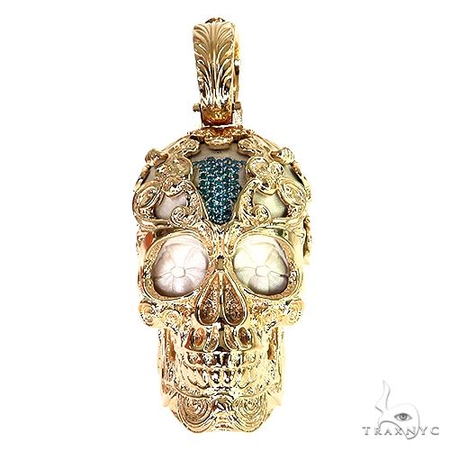 Gold skull pendant with intricate floral engravings and blue stone eyes by TraxNYC