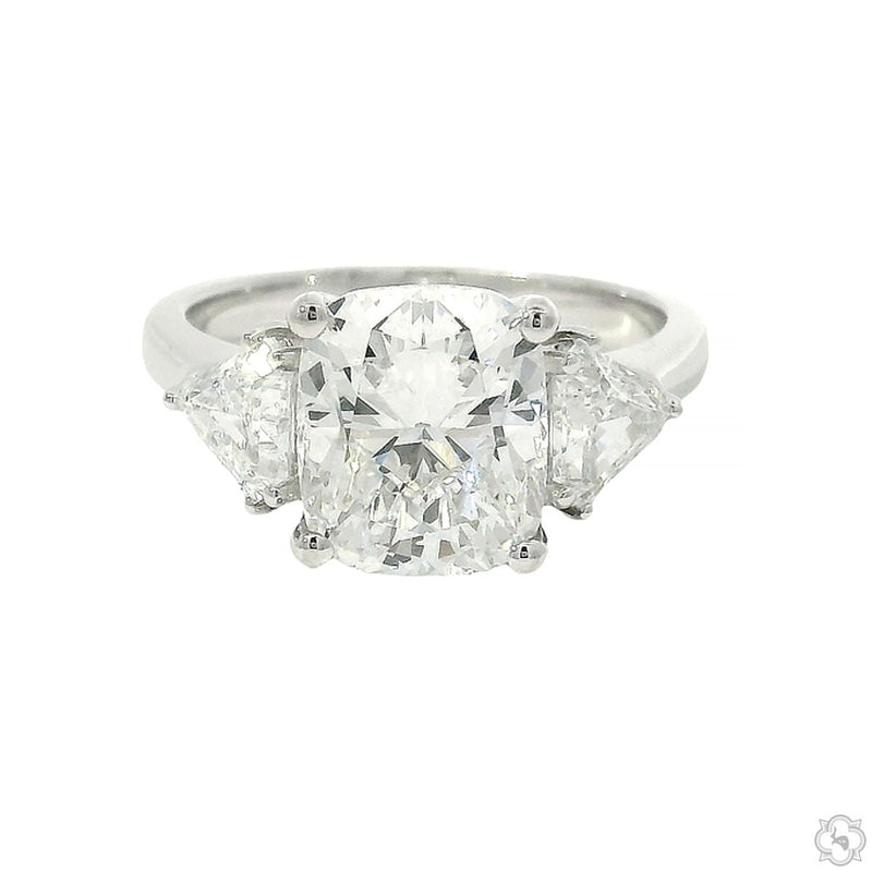 White gold engagement ring with cushion-cut center diamond and two side diamonds