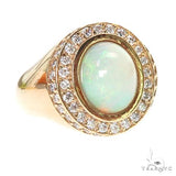 Yellow gold men's ring with central opal surrounded by a halo of diamonds.