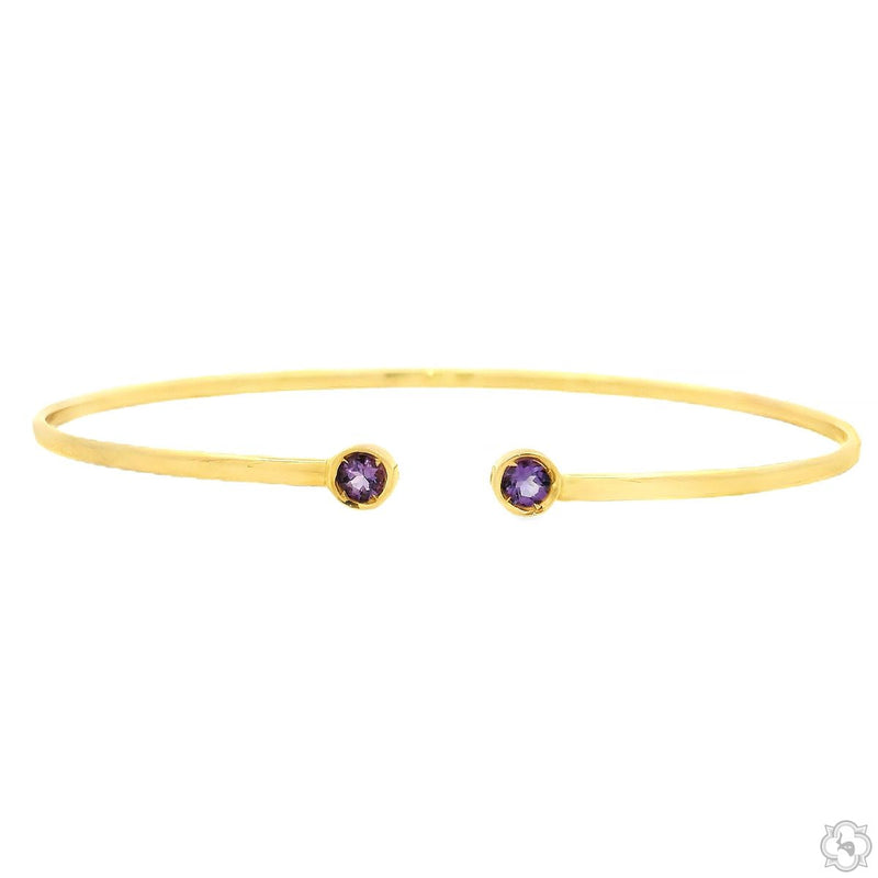 Open gold bangle bracelet with two violet gemstone terminals, polished finish, slight gap at opening