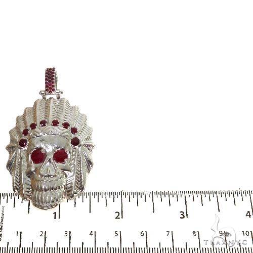 Sterling silver Indian skull pendant with red ruby eyes and accents, measuring about 2 inches tall