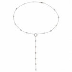 Sterling silver lariat necklace with small bead accents and circular loop detail.
