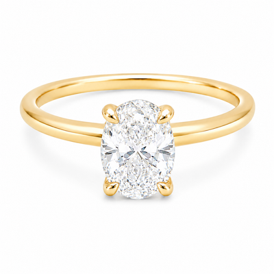 14K yellow gold engagement ring featuring a 1.50 carat oval lab grown diamond in a four-prong setting with a hidden halo and a slim polished solitaire band.