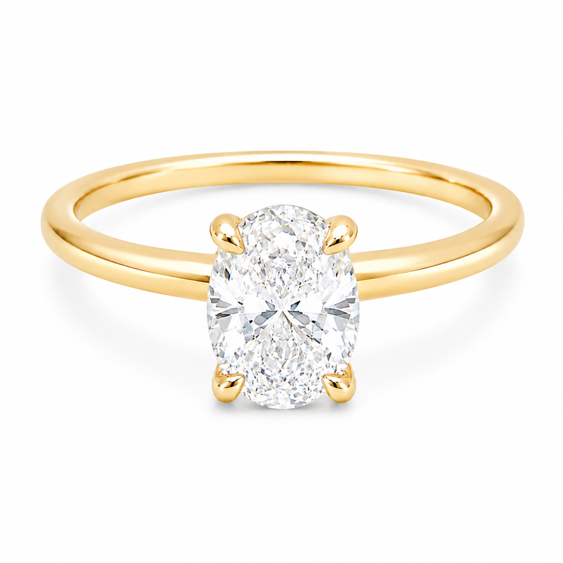 14K yellow gold engagement ring featuring a 1.50 carat oval lab grown diamond in a four-prong setting with a hidden halo and a slim polished solitaire band.