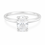 14K gold engagement ring featuring a 1.50 carat oval lab grown diamond in a four-prong setting with a hidden halo and a slim polished solitaire band.