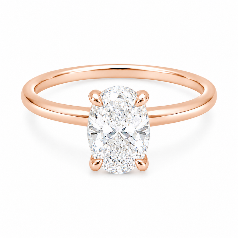 14K gold engagement ring featuring a 1.50 carat oval lab grown diamond in a four-prong setting with a hidden halo and a slim polished solitaire band.