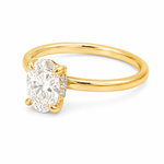 14K yellow gold engagement ring featuring a 1.50 carat oval lab grown diamond in a four-prong setting with a hidden halo and a slim polished solitaire band.