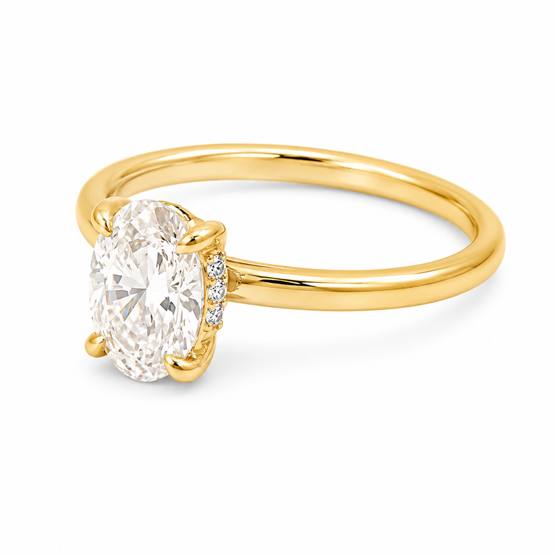 14K yellow gold engagement ring featuring a 1.50 carat oval lab grown diamond in a four-prong setting with a hidden halo and a slim polished solitaire band.