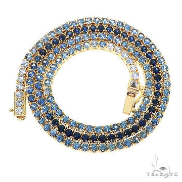 Yellow gold tennis chain necklace with alternating dark and light blue sapphire stones.