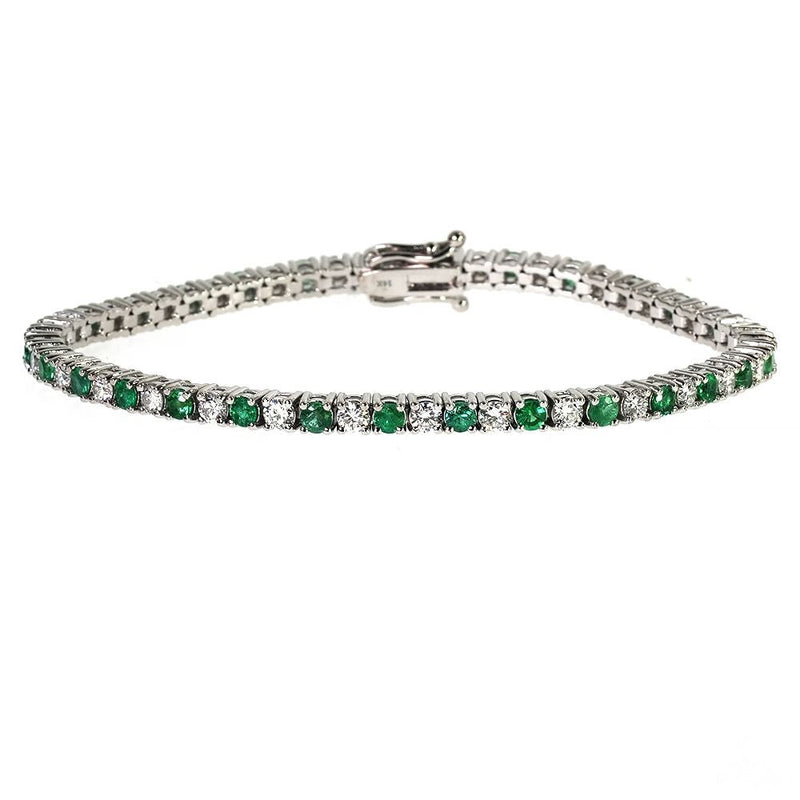 White gold tennis bracelet with alternating emerald and diamond gemstones