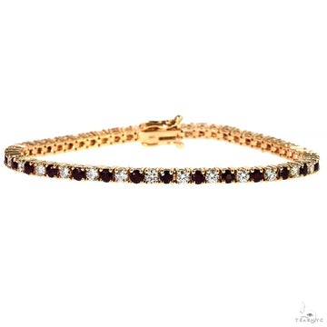 Yellow gold tennis bracelet with alternating ruby and diamond gemstones.