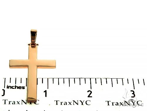 14K yellow gold solid mens cross pendant with polished finish, next to ruler for size reference
