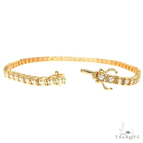 14K yellow gold bracelet with round-cut diamonds in a classic tennis design