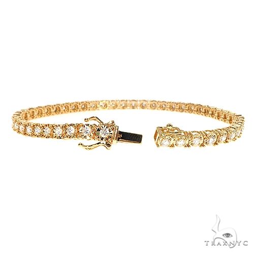 14K yellow gold bracelet with round-cut diamonds in a classic tennis design