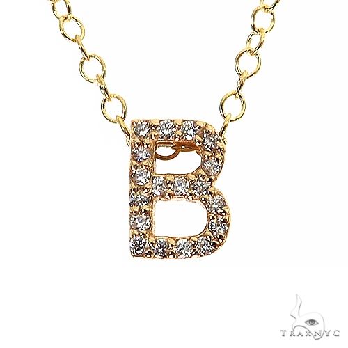 Yellow gold chain necklace with diamond-encrusted letter B pendant, delicate and sparkling