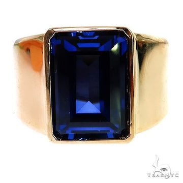 14K gold men’s ring with large rectangular deep blue sapphire gemstone centerpiece.