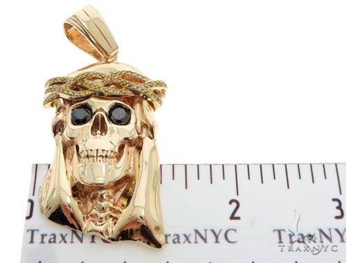 14K yellow gold skull pendant with black eyes and diamond crown of thorns detailing