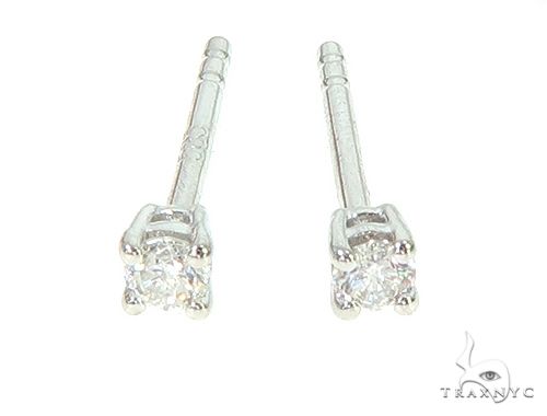 14K white gold solitaire diamond stud earrings with four-prong setting.