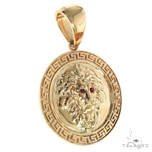 14K yellow gold lion head pendant with Greek key border and red gemstone eyes