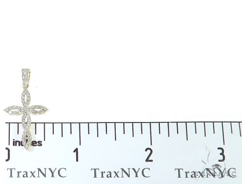 14K yellow gold twisted cross pendant with diamond accents, measuring just over 1 inch tall