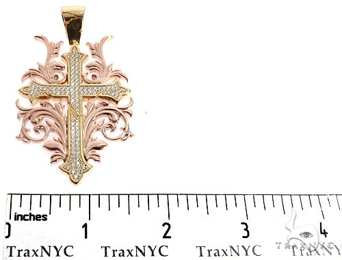 Two-tone 14k gold filigree cross pendant with diamond accents and intricate floral design