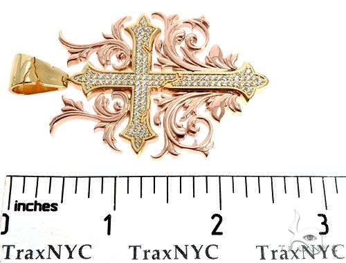 Two-tone 14k gold cross pendant with diamond filigree and ornate rose gold detailing