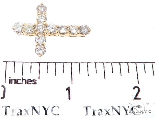 14k yellow gold cross pendant with round diamonds, small size shown on ruler under 1 inch